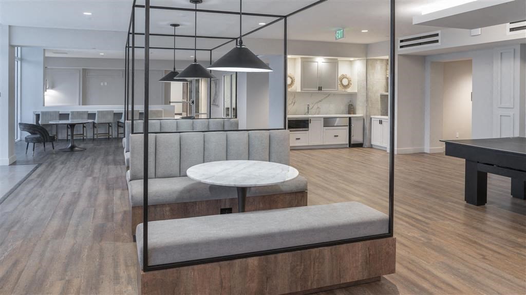 A modern kitchen with a dining table and chairs.