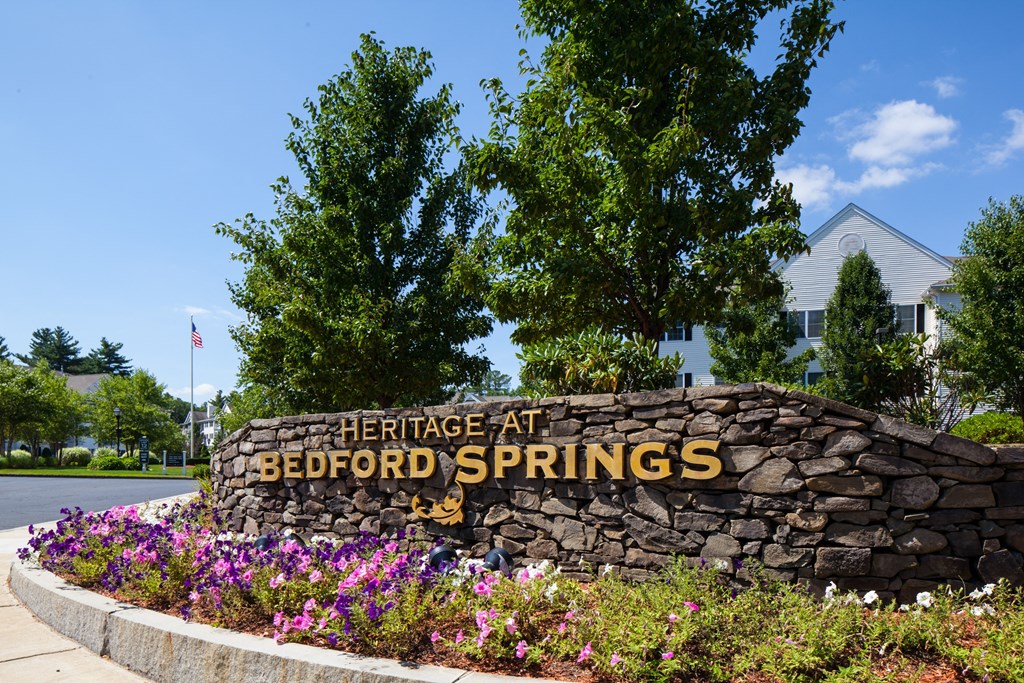 a stone wall with a sign that reads heritage