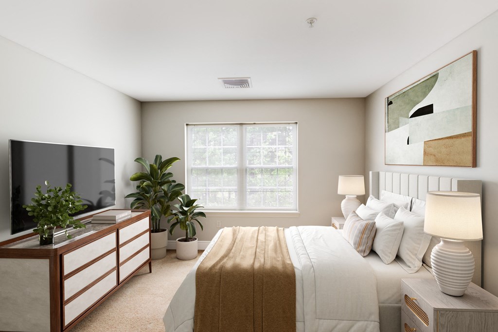 a bedroom with a large bed and a tv