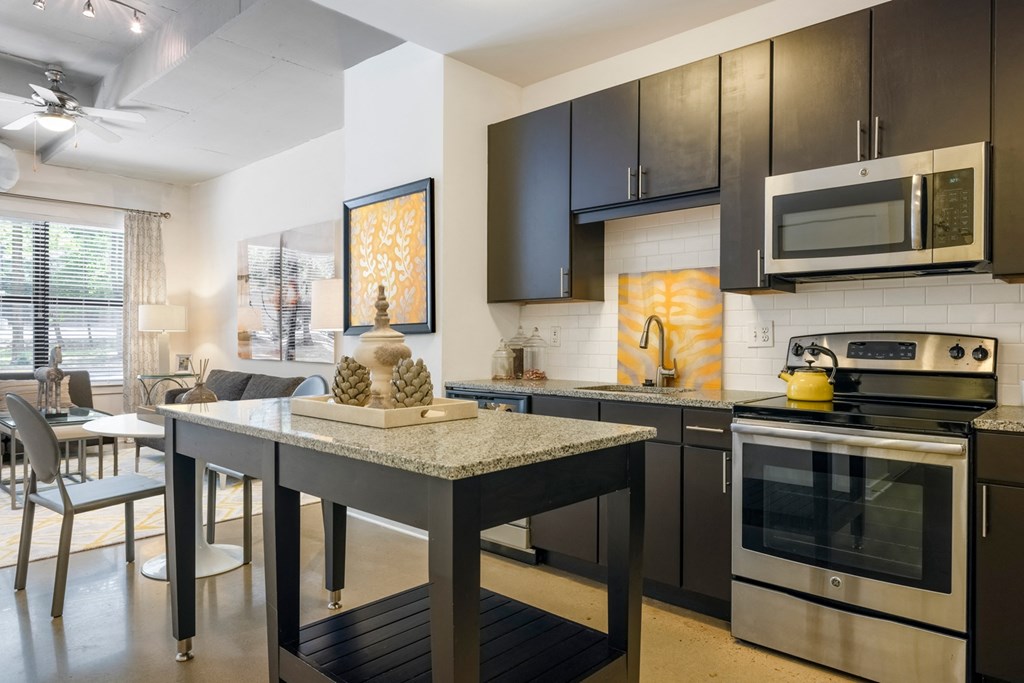 A modern kitchen with a table and chairs.