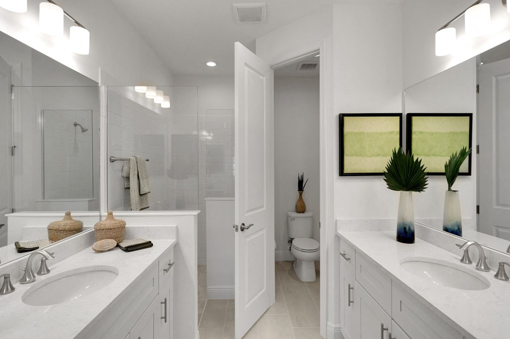 a bathroom with two sinks and a mirror
