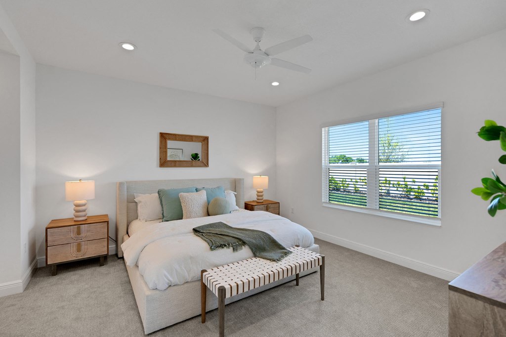 a bedroom with a bed and a ceiling fan