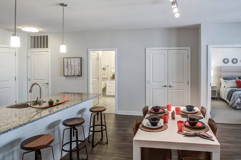 a kitchen and dining area with a table and chairs