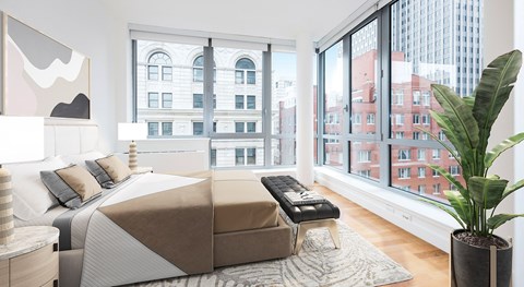 A bedroom with a large bed and a view of the city.