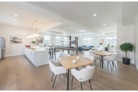 A modern kitchen with a dining table and chairs.