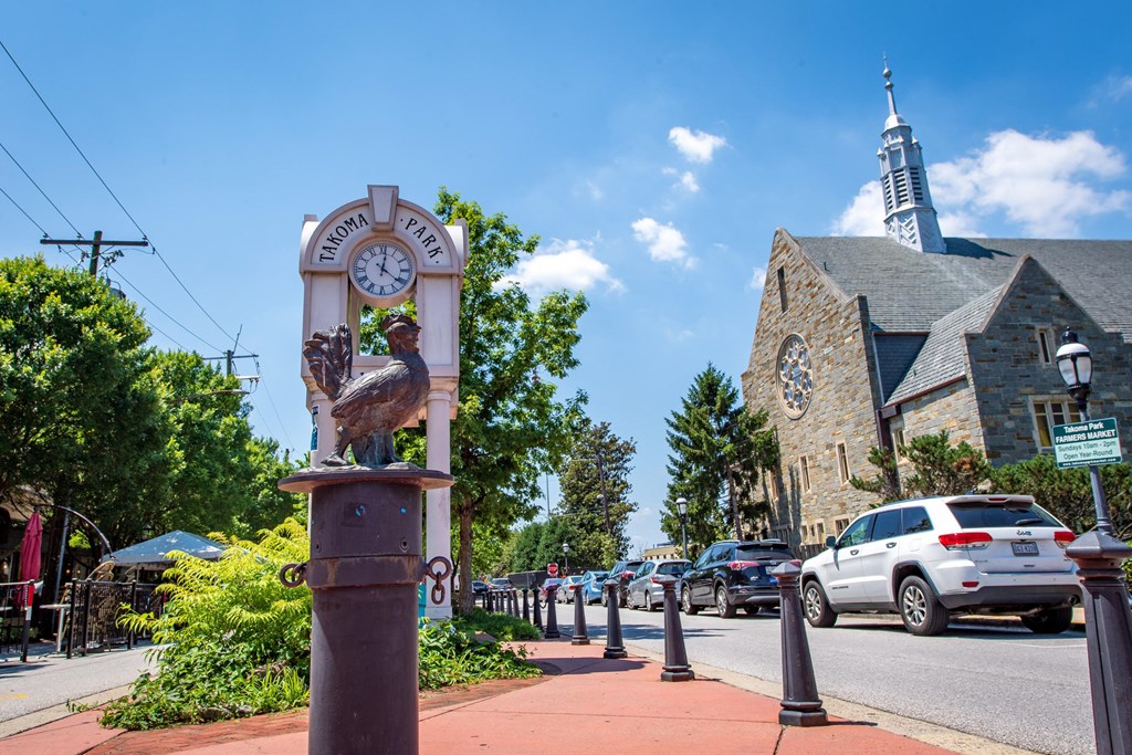 a bird statue on the sidewalk in front of a church