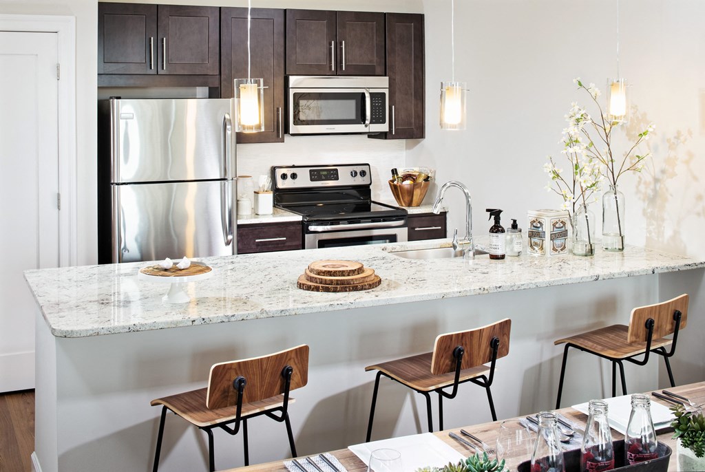 a kitchen with a marble counter top and stainless steel appliances