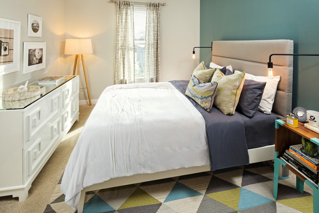 a bedroom with a bed and a dresser