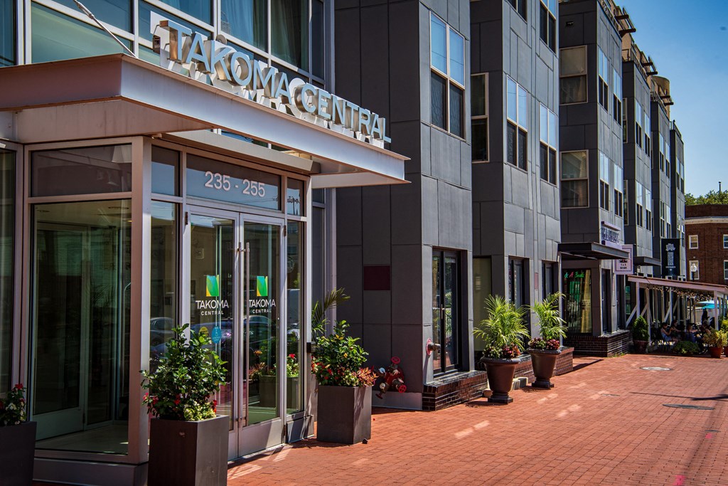 a view of the front of a building with potted plants in front of it
