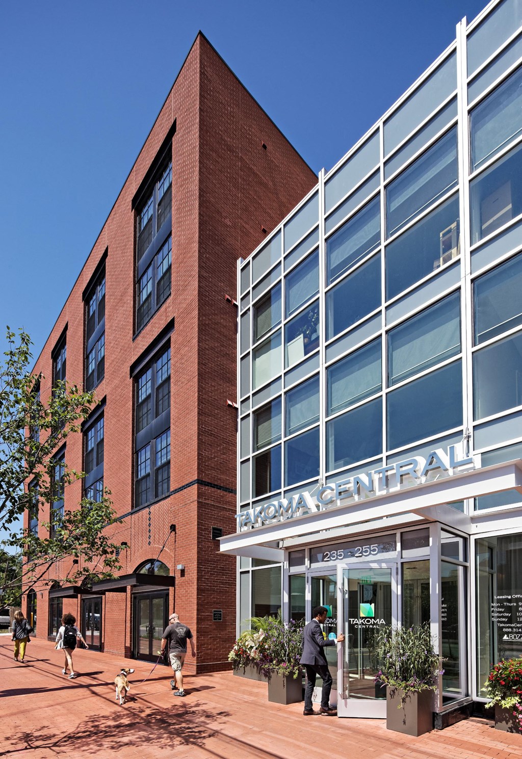 a large brick building with people walking in front of it