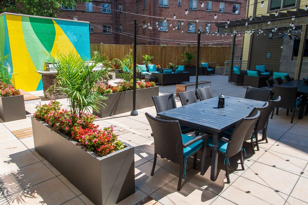 a patio with a table and chairs and a large colorful mural