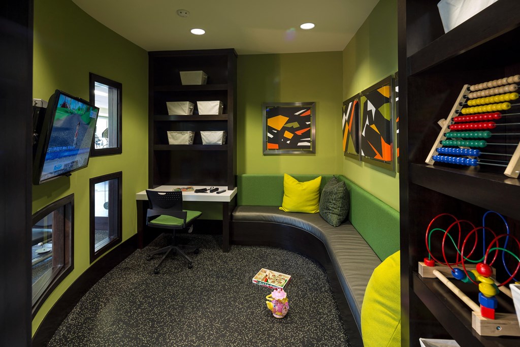 a childs play room with a desk and a chair