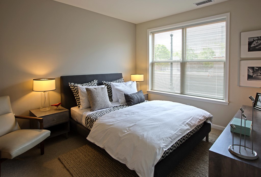 a bedroom with a large bed and a window