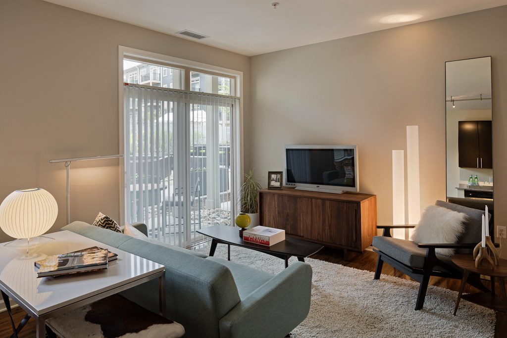 a living room with a couch and a table and a television