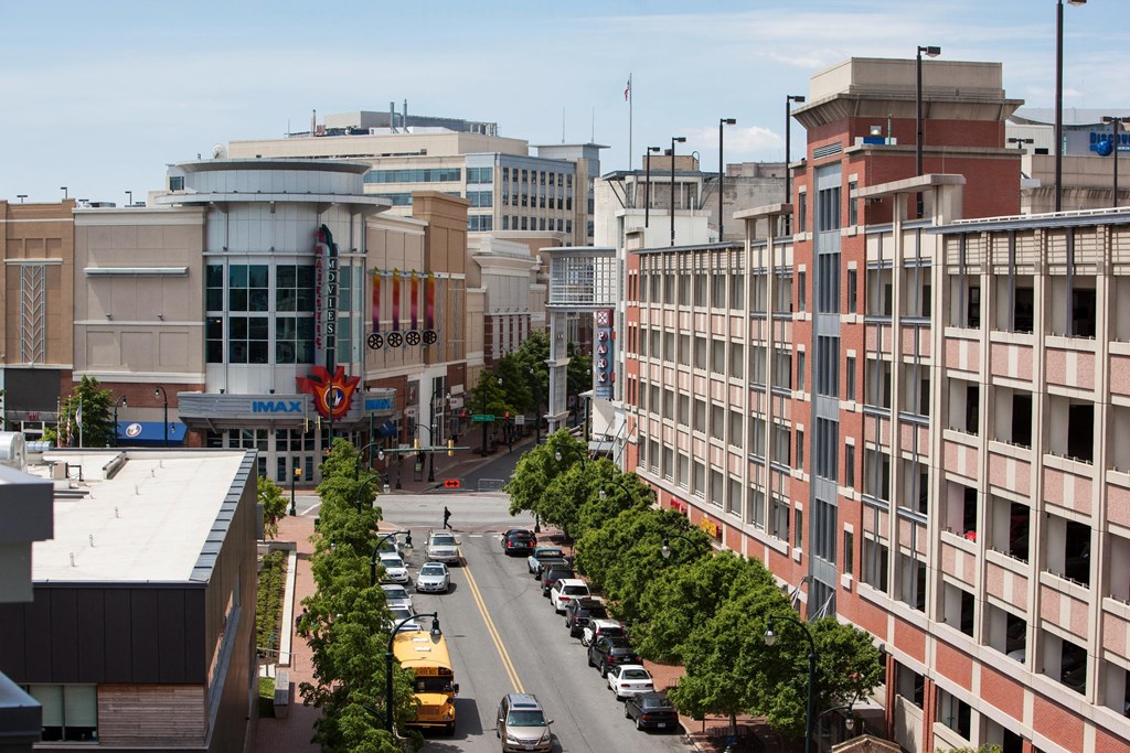 an aerial view of a city street with cars and buildings