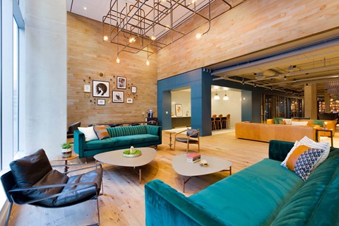 A living room with a black chair and a green couch.