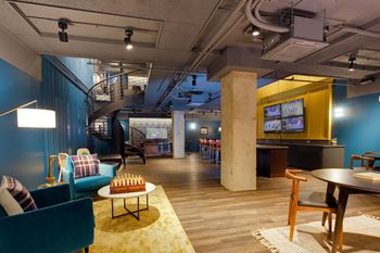 A room with a blue wall and a yellow rug.