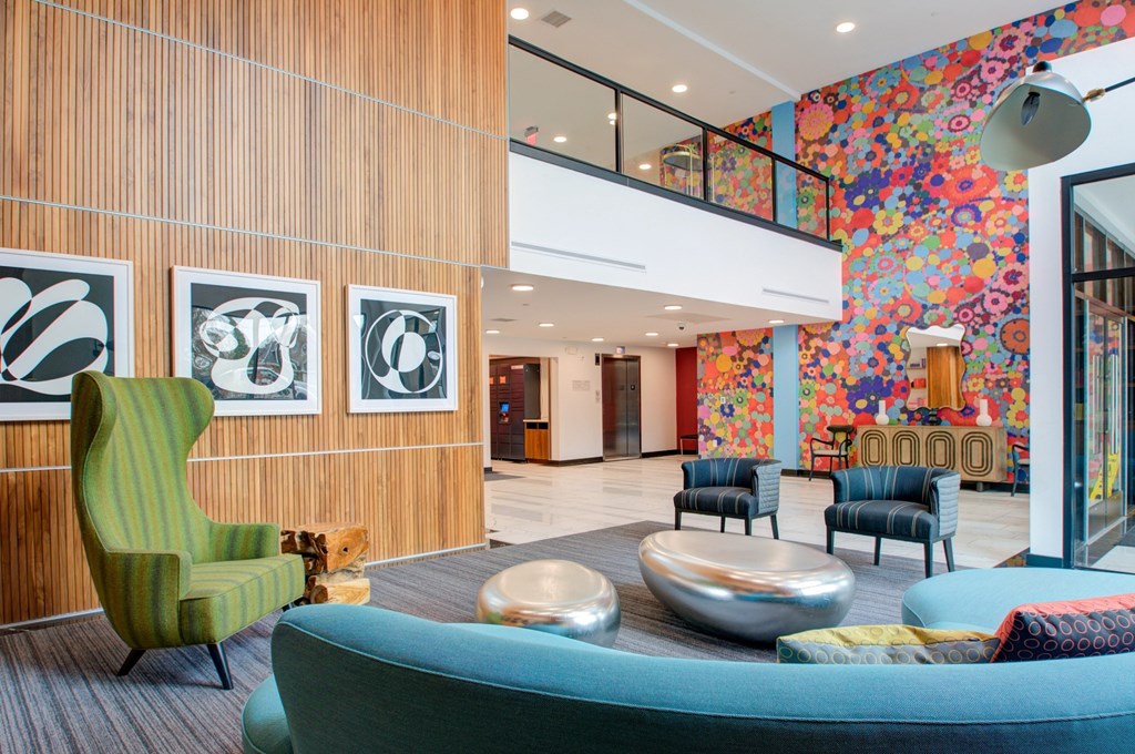 A room with a blue chair and a green chair.