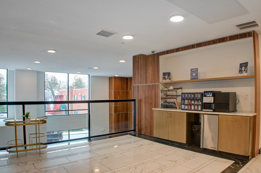 A reception area with a counter and a balcony with a view of the outside.