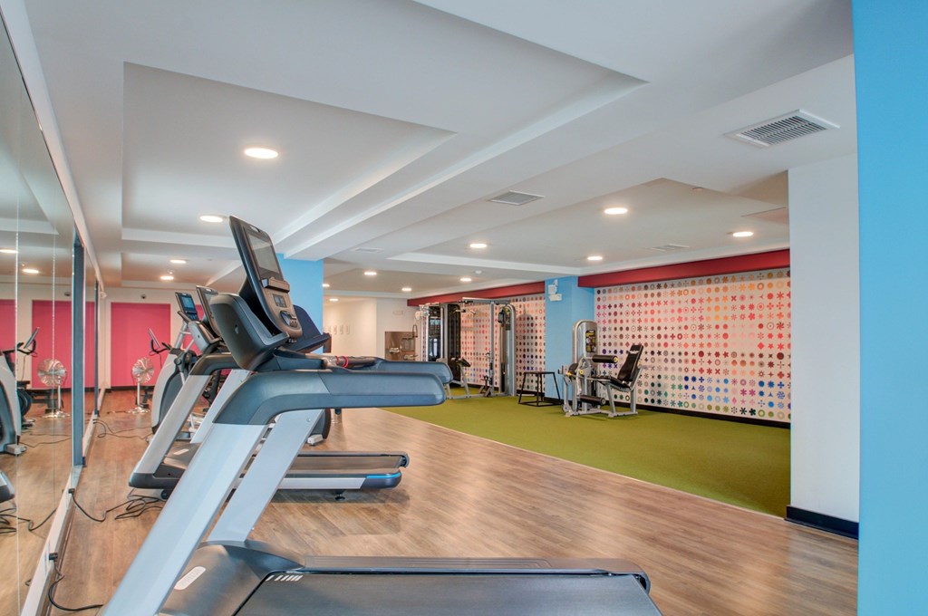 A gym with treadmills and exercise equipment.