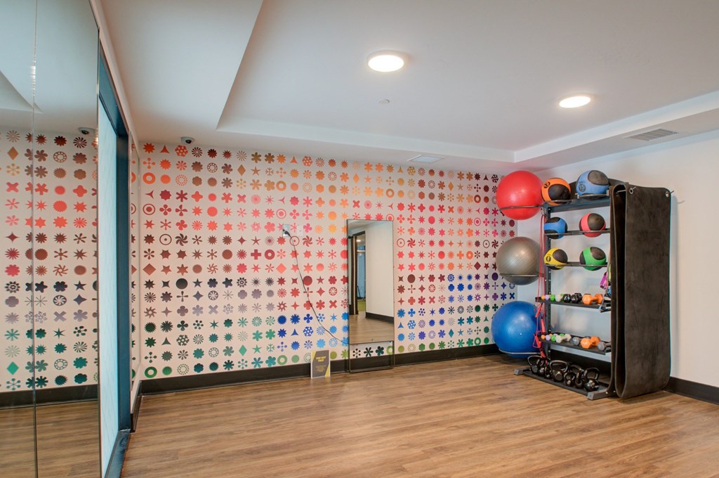 A room with a wall covered in buttons and a ball machine.