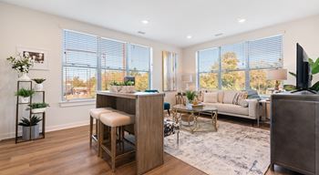 A modern living room with a bar stool and a couch.