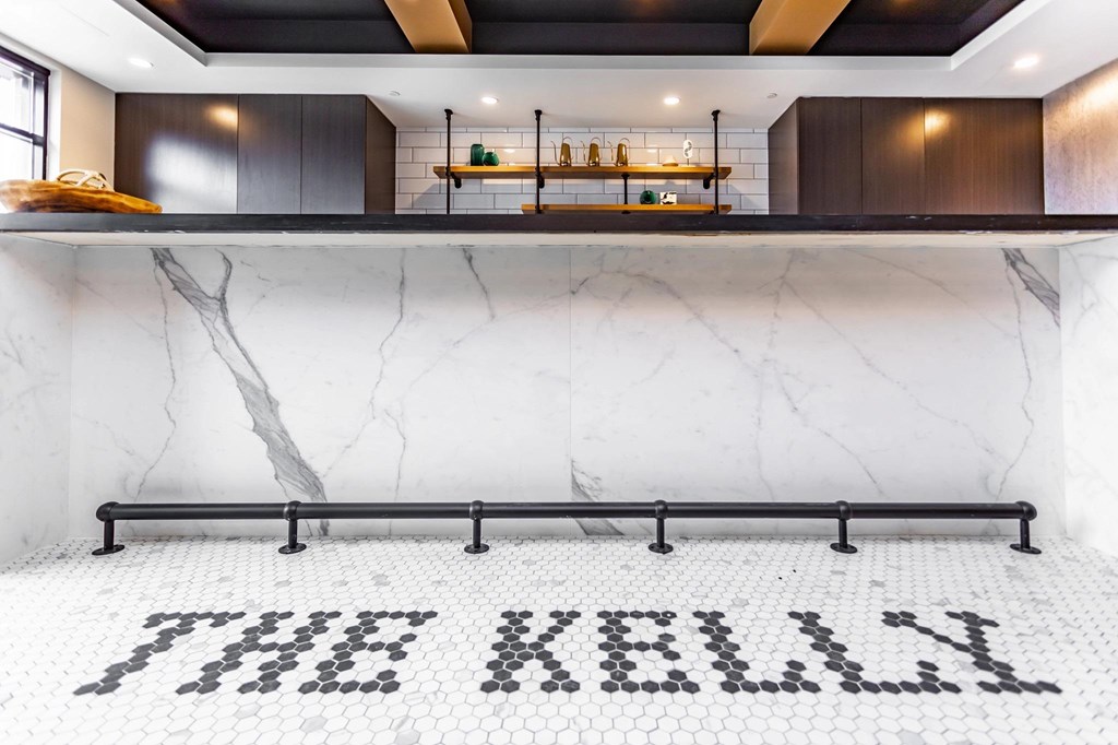 A white marble floor with black letter tiles spelling out