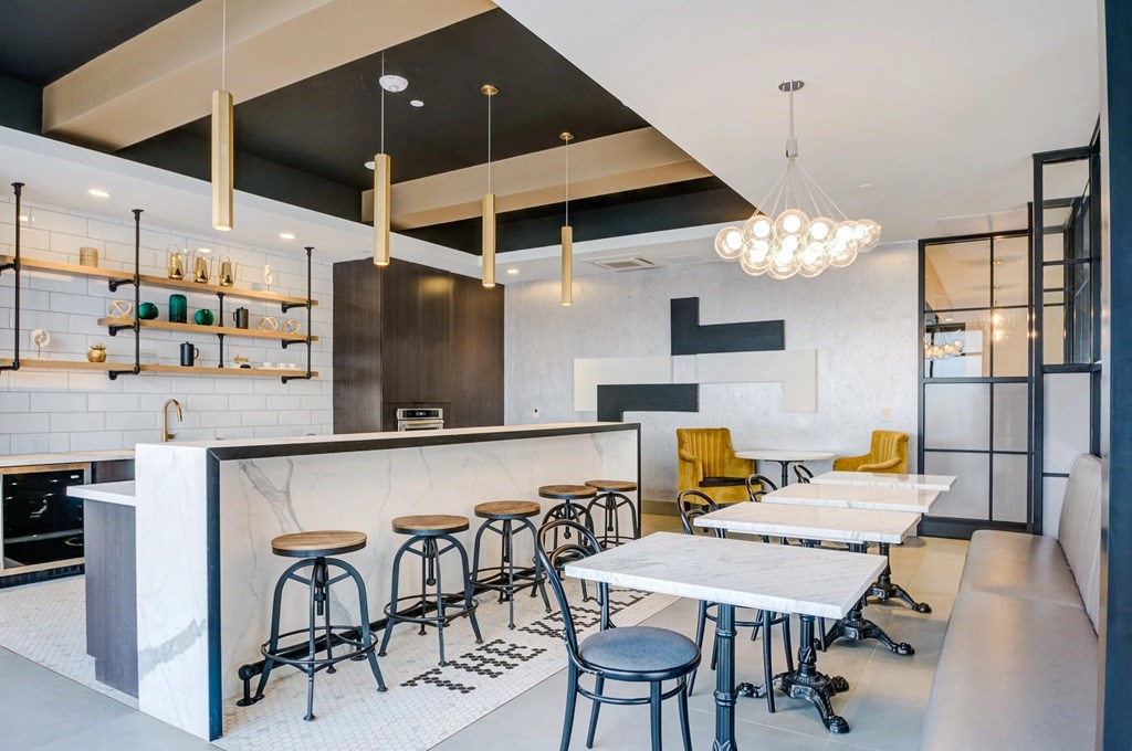 A modern bar with stools and a counter.