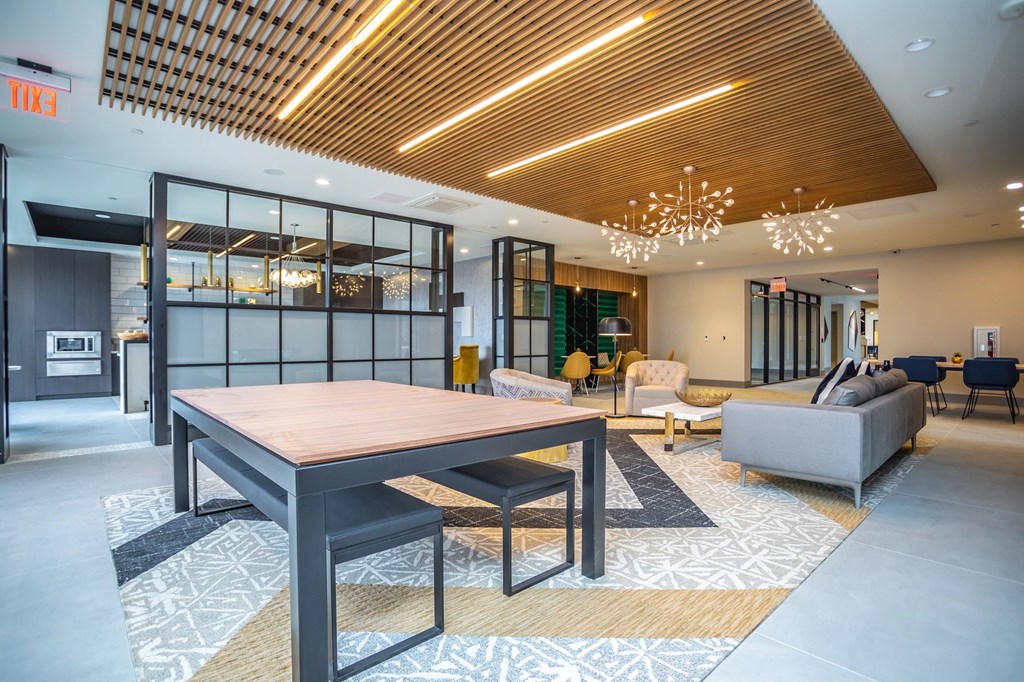A modern dining room with a wooden table and chairs.