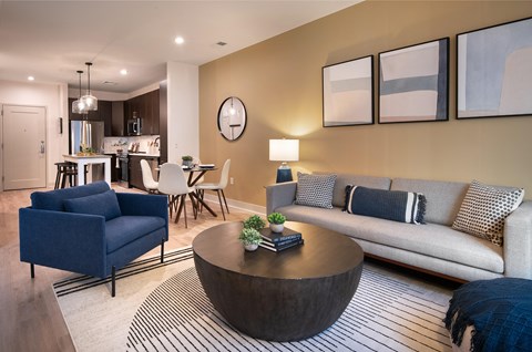 A living room with a blue couch and a coffee table.