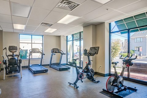 A gym with treadmills, exercise bikes, and elliptical machines.