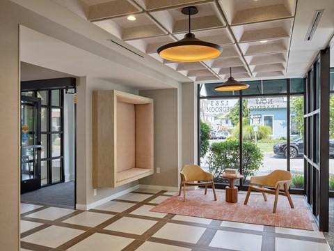 A modern waiting area with a checkered floor and a large window.