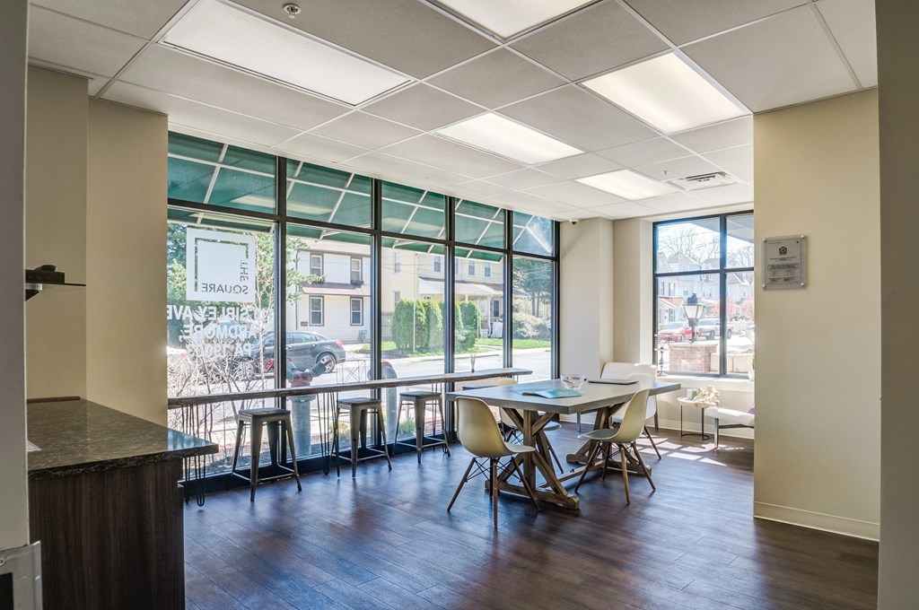 A conference room with a long table and chairs.