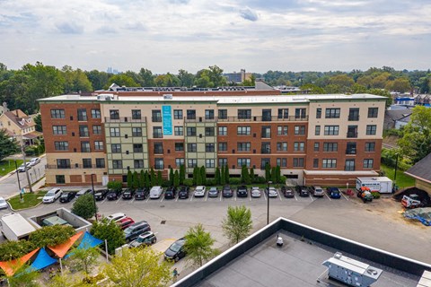 A large multi-story building with a parking lot in front.