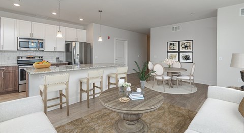 A modern kitchen with a dining table and chairs.