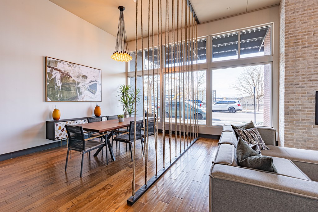 A modern living room with a wooden floor and a large window.