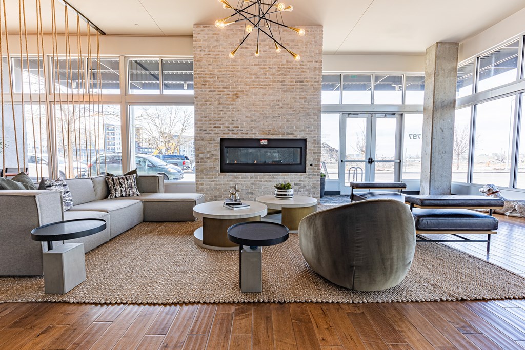 A living room with a brick fireplace and a television.