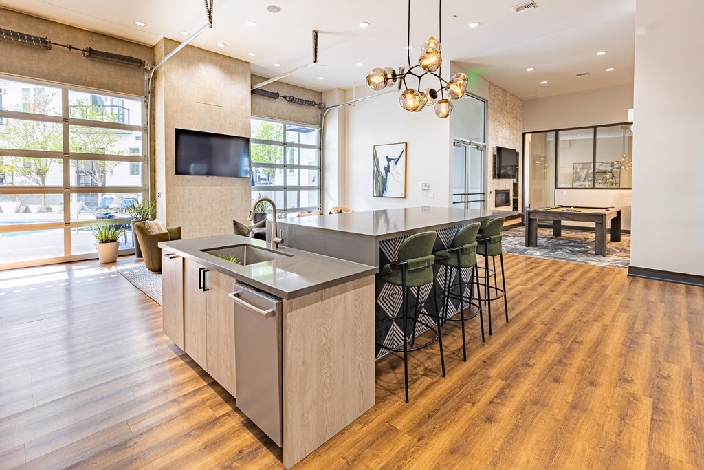A modern kitchen with a wooden floor and a large island.
