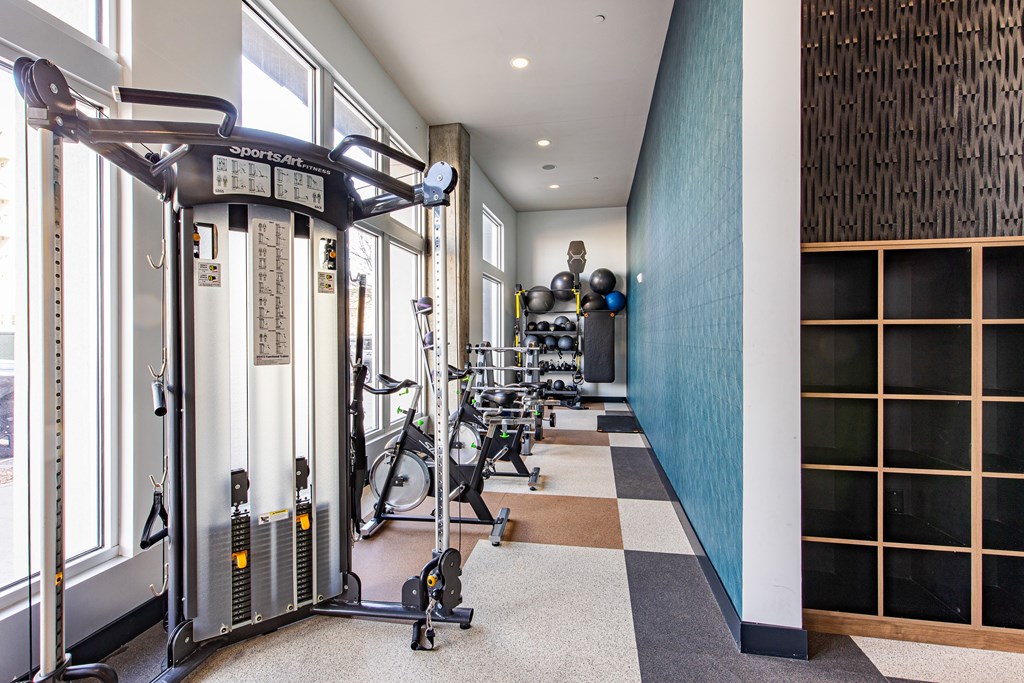 A gym with a row of treadmilers.