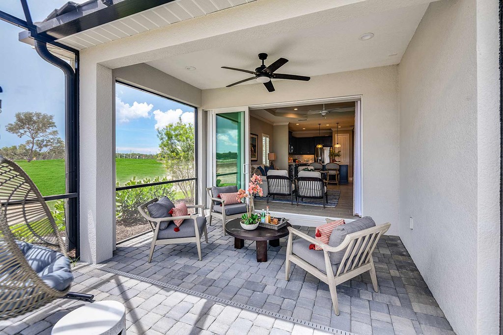 A balcony with lounge chairs and a ceiling fan  at Marisol, Bradenton, 34211