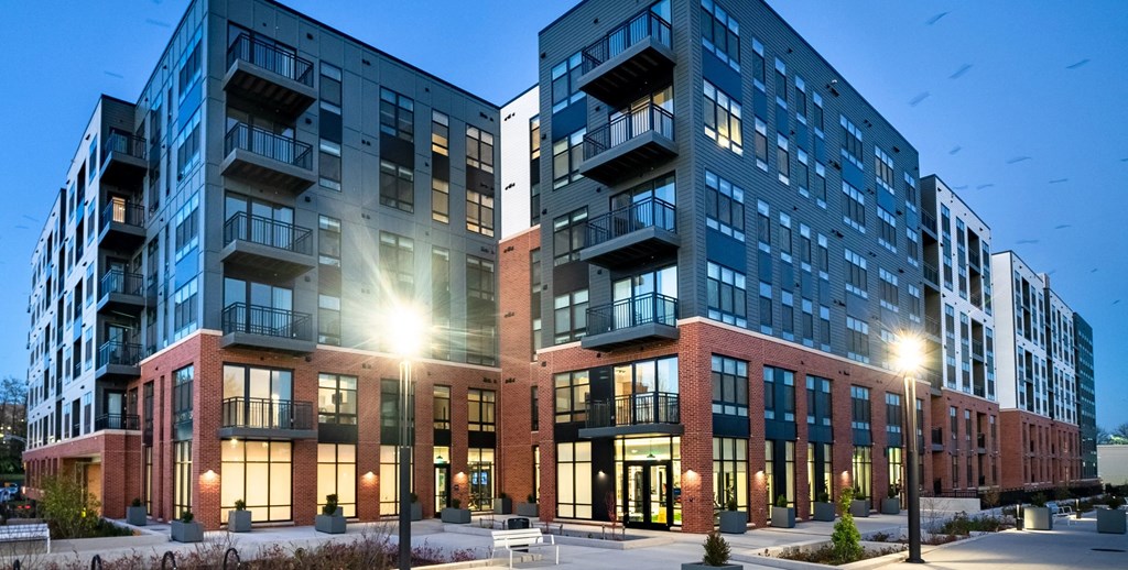 an exterior view of an apartment building at dusk