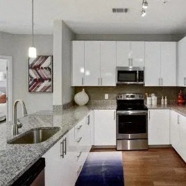 a kitchen with white cabinets and a sink