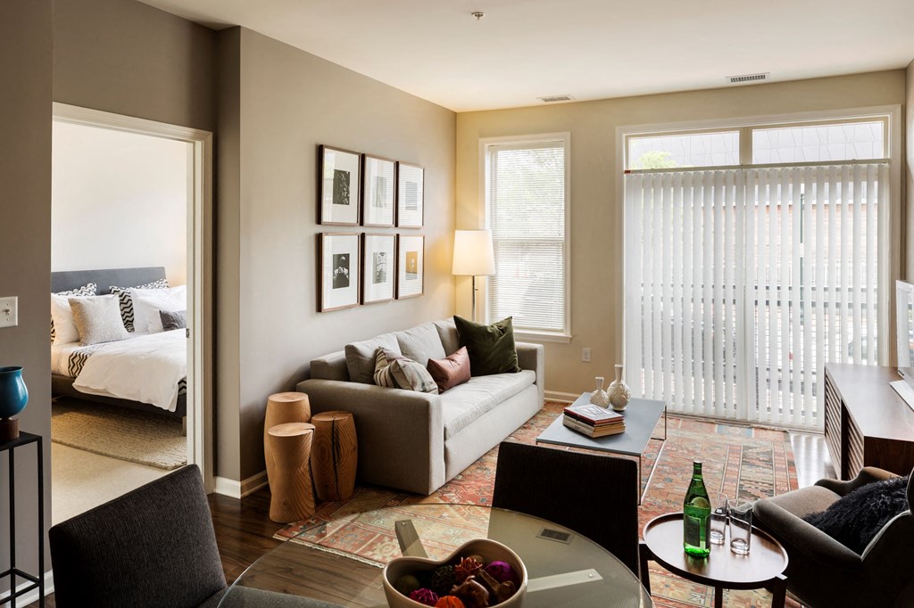 A living room with a couch, coffee table and wall art.