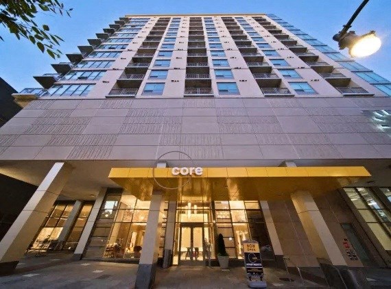 a view of the facade of a tall building with a lobby