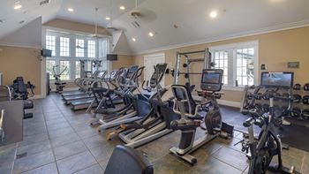 A gym with treadmills, exercise bikes, and other equipment.