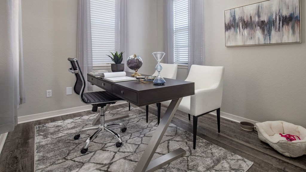 A modern dining room with a table and chairs.