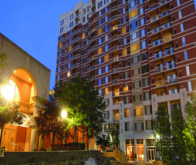 a city at night with a tall building