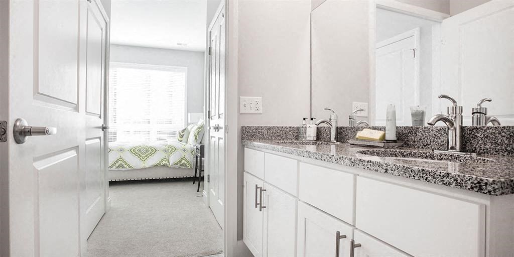 a white bathroom with a sink and a mirror