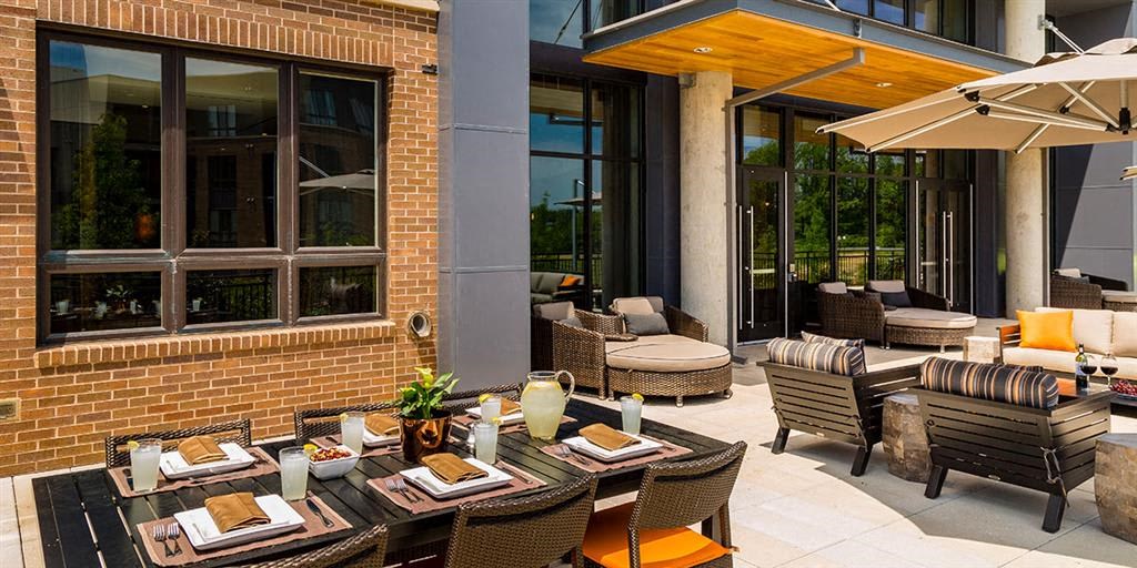 a patio with tables and chairs outside of a building