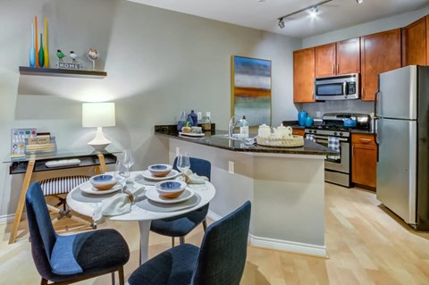 A kitchen with a dining table set for two.